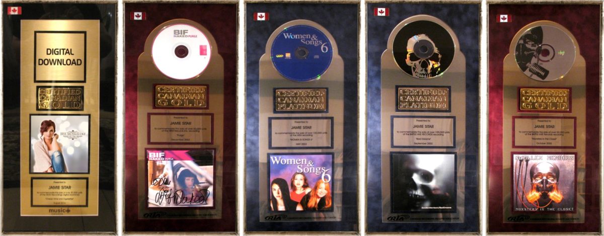 Music award plaques with various album covers.